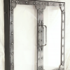 Fireplace doors in antique nickel with polished rivets. These doors fit within a fireplace opening, and rather than having a wire mesh screen, these doors employ fireproof glass giving the project a very tidy overall feel. By Archive Designs.